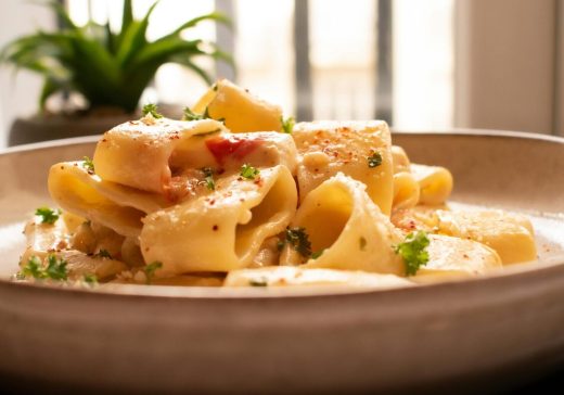 Delicious creamy pasta garnished with parsley, perfect for a cozy meal at home.